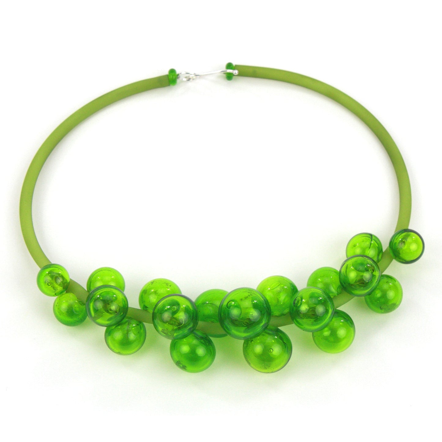 A vibrant green Chroma necklace featuring clustered handblown glass beads strung on steel wire and threaded through a green hand-dyed silicone cord with a sterling silver clasp.