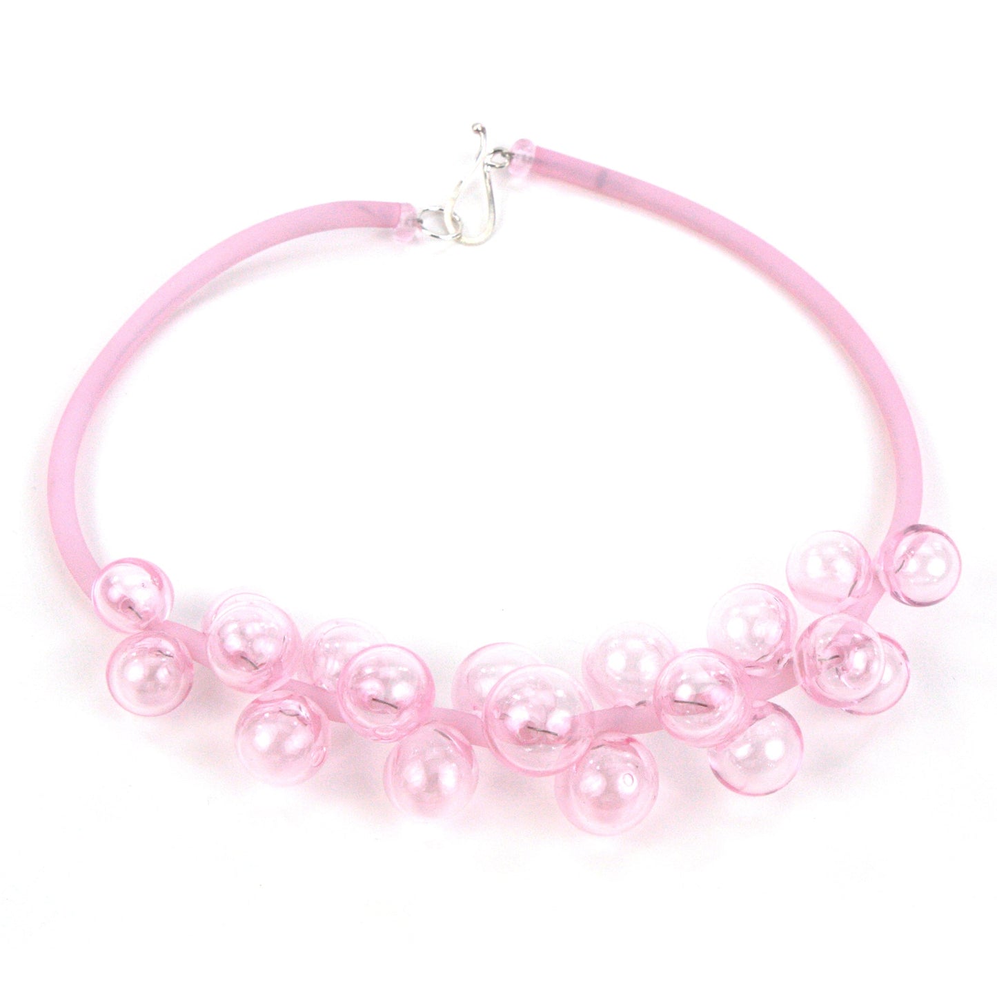 A pastel pink Chroma necklace showcasing clusters of handblown glass beads strung on steel wire and threaded through a hand-dyed pink silicone cord with a sterling silver clasp.