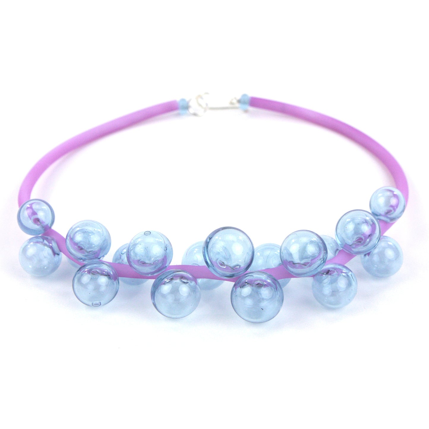 A delicate purple Chroma necklace featuring clusters of handblown lavender glass beads strung on steel wire and a hand-dyed silicone cord with a sterling silver clasp.