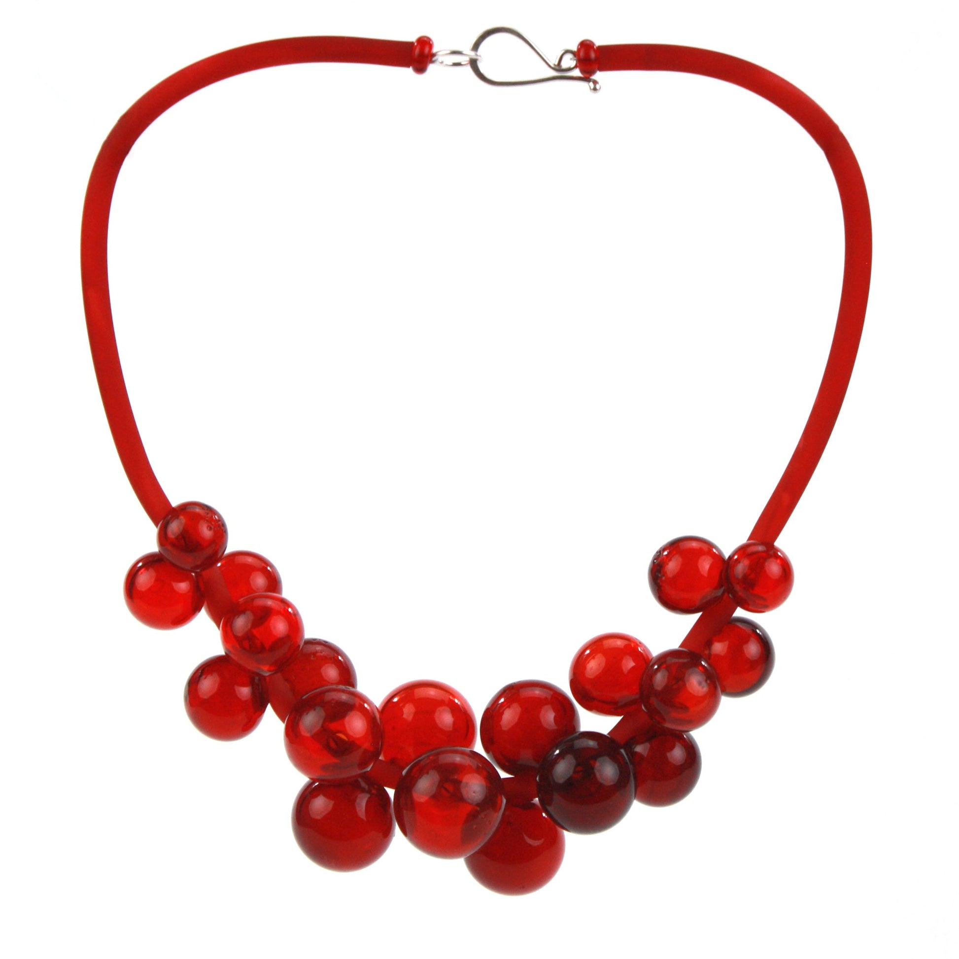 A bold red Chroma necklace featuring clusters of handblown glass beads strung on steel wire and a hand-dyed silicone cord with a sterling silver clasp.
