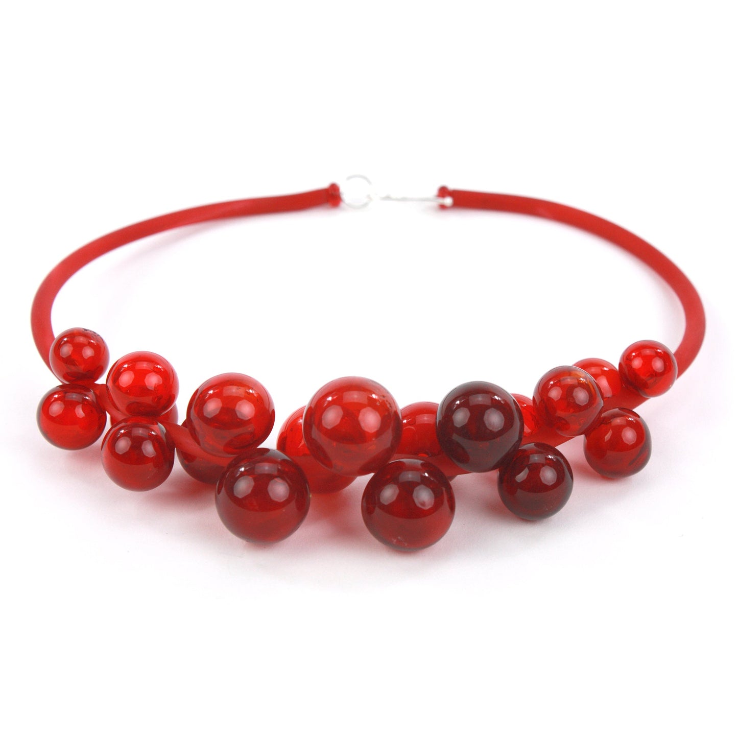 A bold red Chroma necklace featuring clusters of handblown glass beads strung on steel wire and a hand-dyed silicone cord with a sterling silver clasp.