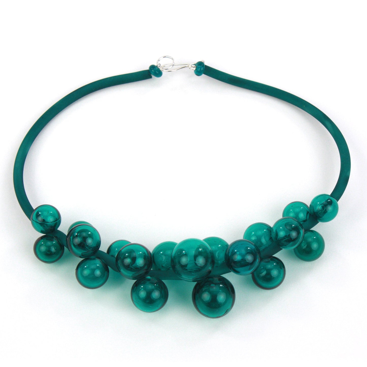 Chroma necklace featuring a cluster of teal handmade glass beads strung on steel and threaded through a hand-dyed silicone cord with a sterling silver clasp.