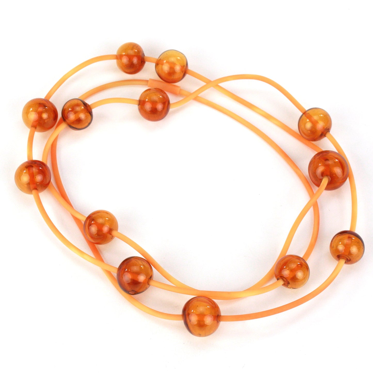 Amber Orbit Necklace with handblown glass beads on a hand-dyed silicone cord, featuring adjustable bead positions and multiple styling options.