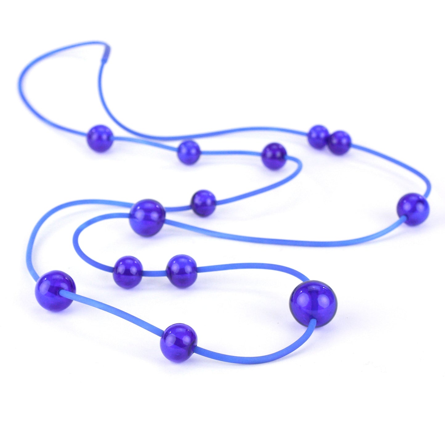Cobalt Orbit Necklace featuring vibrant handblown glass beads on a hand-dyed silicone cord, adjustable for versatile wear as a long or layered piece.