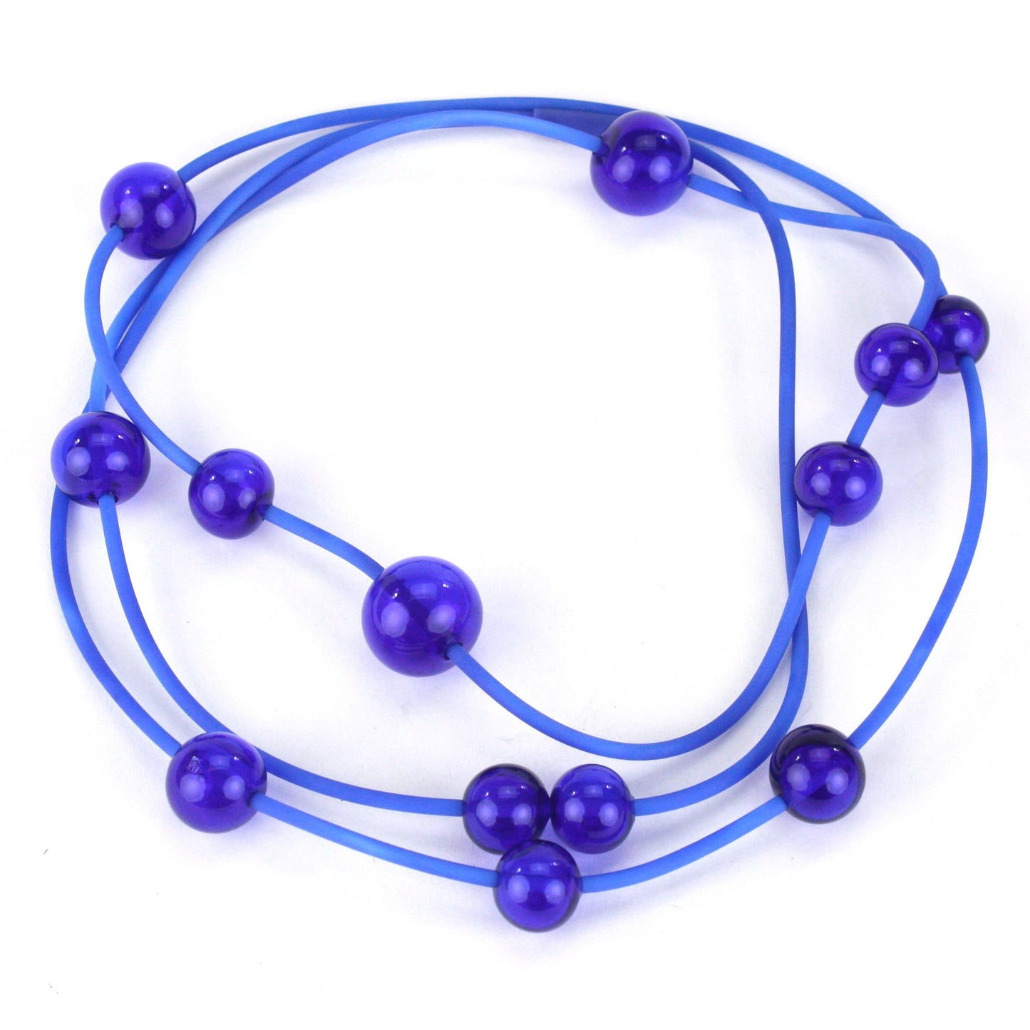 Cobalt Orbit Necklace featuring vibrant handblown glass beads on a hand-dyed silicone cord, adjustable for versatile wear as a long or layered piece.