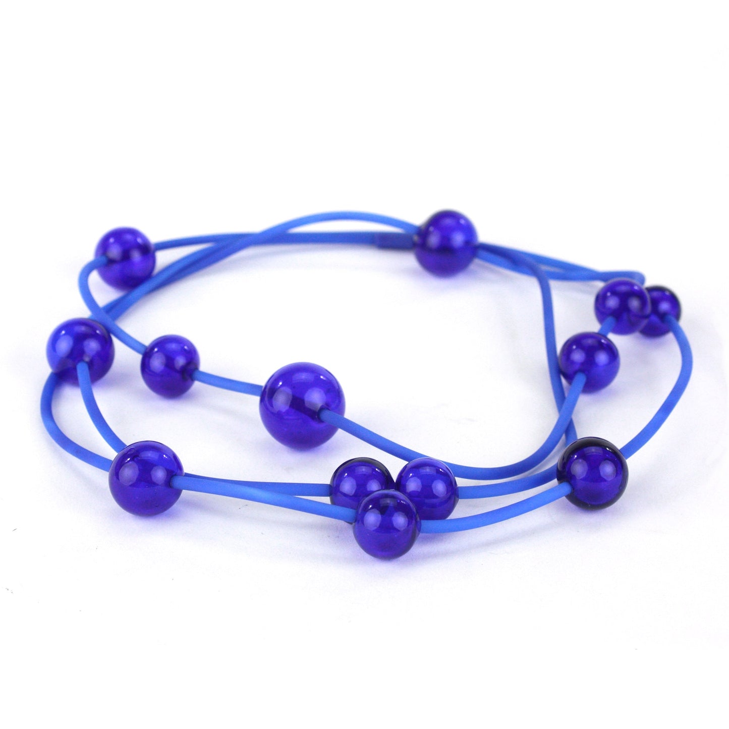 Cobalt Orbit Necklace featuring vibrant handblown glass beads on a hand-dyed silicone cord, adjustable for versatile wear as a long or layered piece.