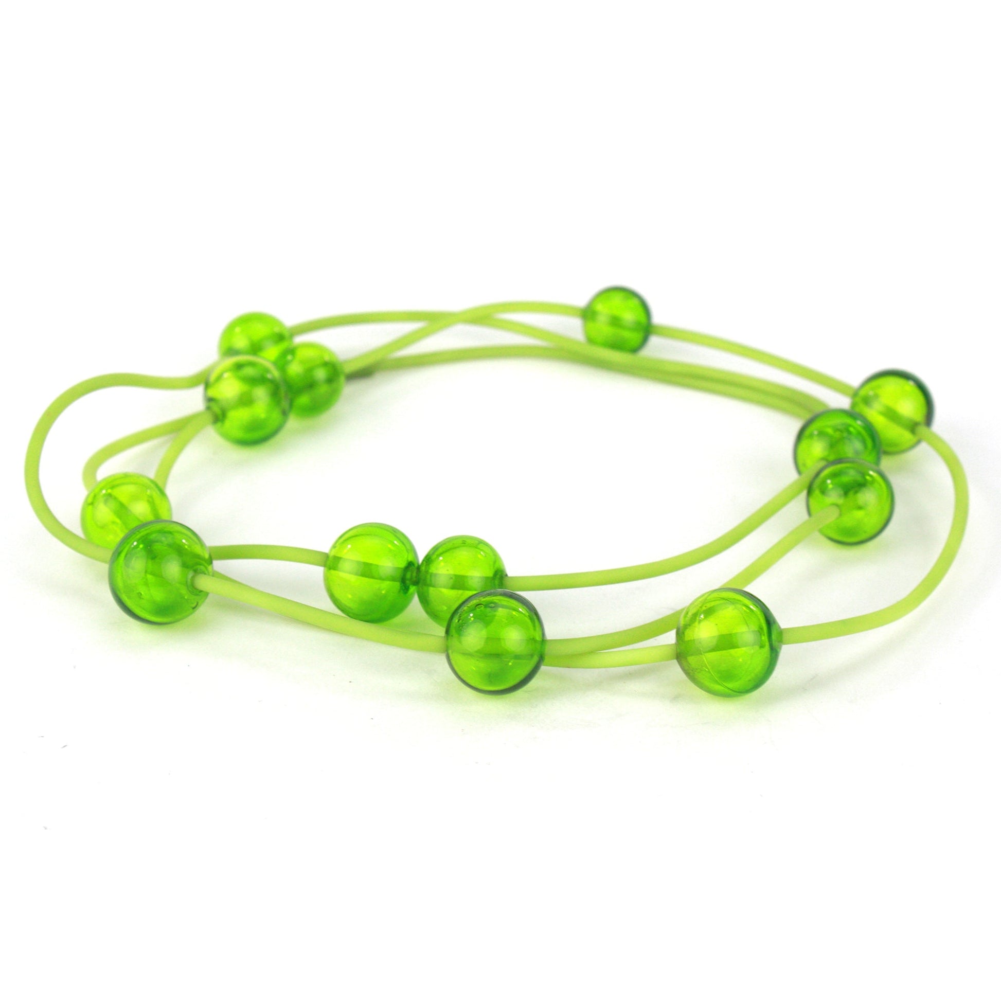 Orbit Necklace in Lime with handblown glass beads on a hand-dyed silicone cord. Features adjustable beads for customizable styling options.