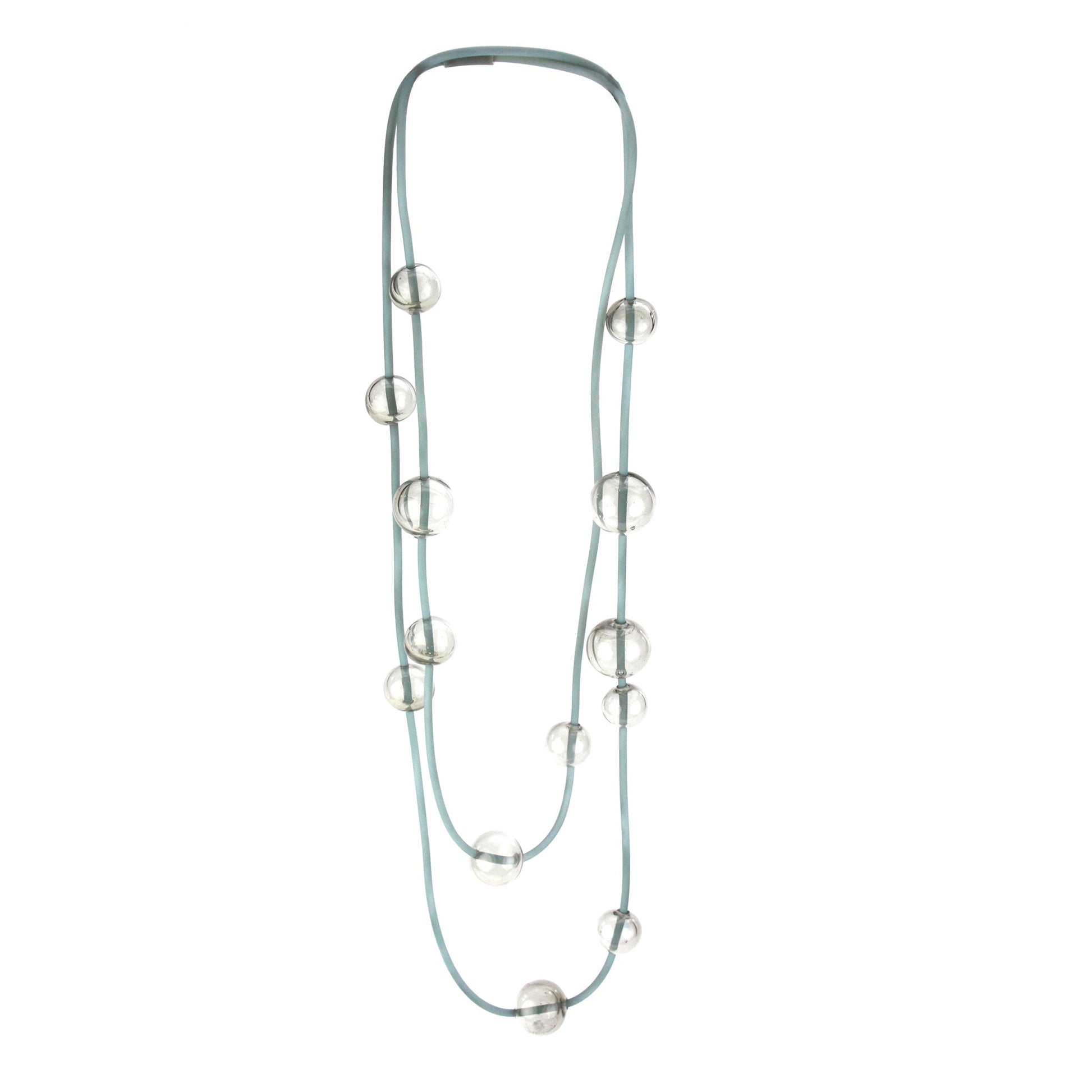 Orbit Necklace in Smoky Grey with handblown glass beads and hand-dyed silicone cord. Features adjustable beads for versatile styling options.