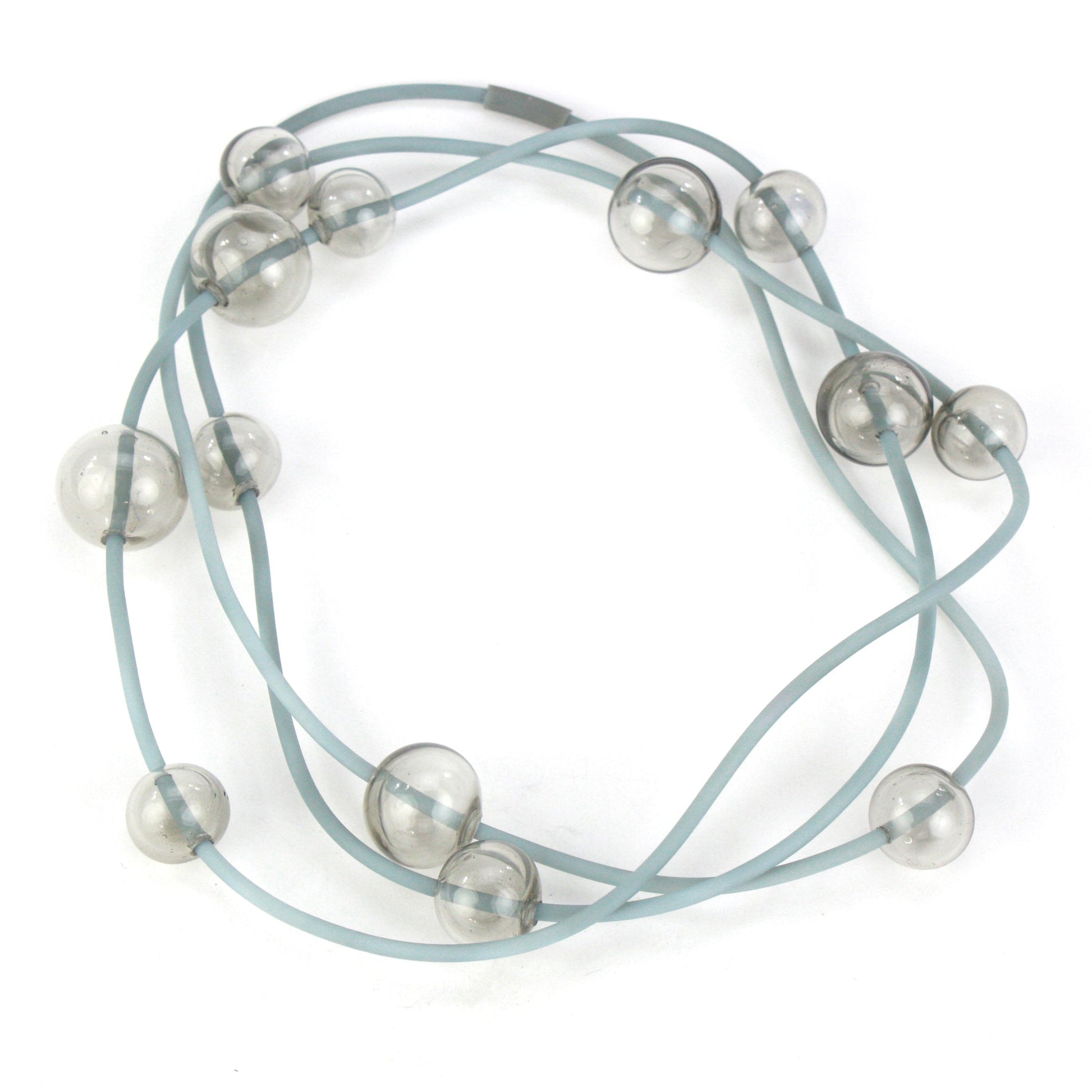 Orbit Necklace in Smoky Grey with handblown glass beads and hand-dyed silicone cord. Features adjustable beads for versatile styling options.