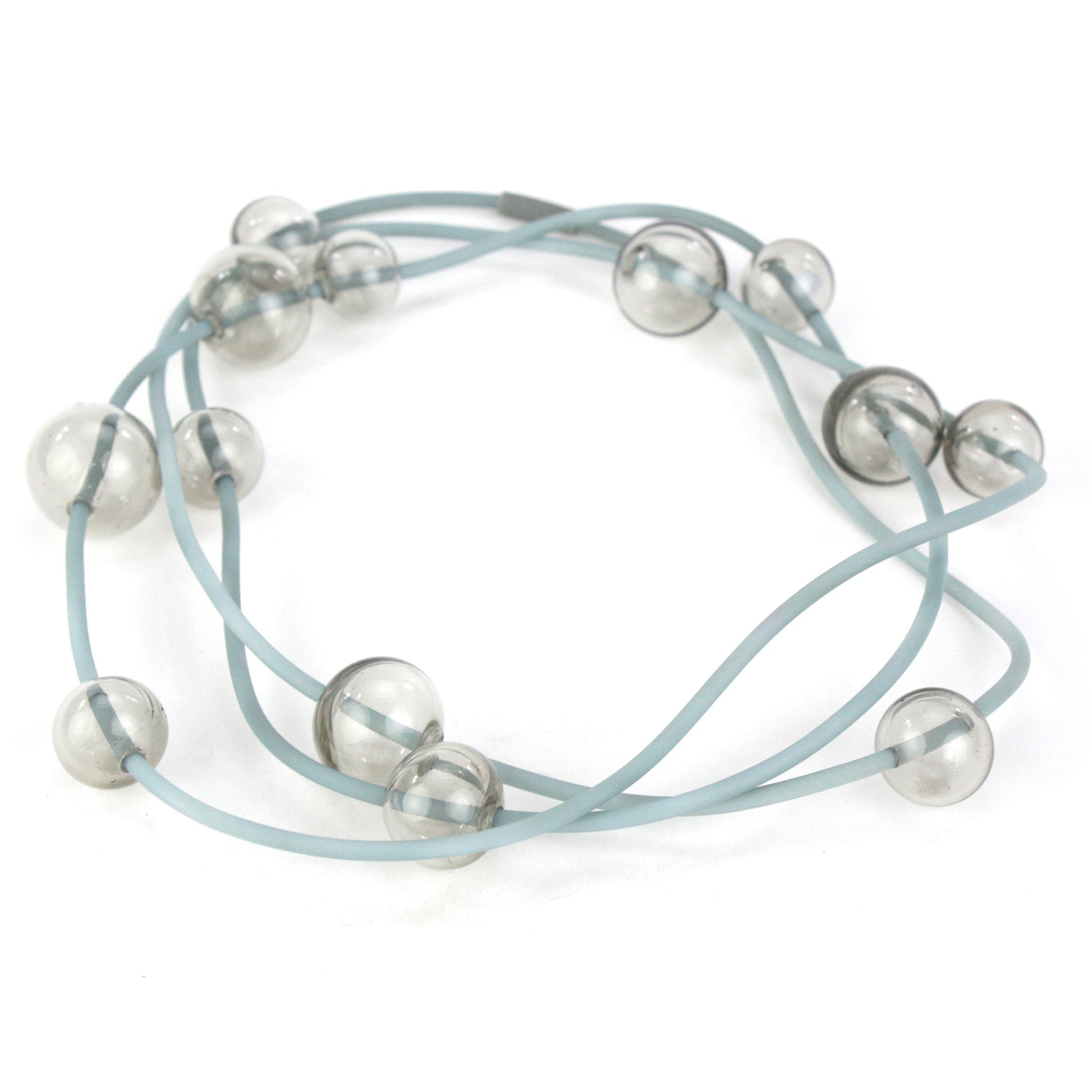 Orbit Necklace in Smoky Grey with handblown glass beads and hand-dyed silicone cord. Features adjustable beads for versatile styling options.