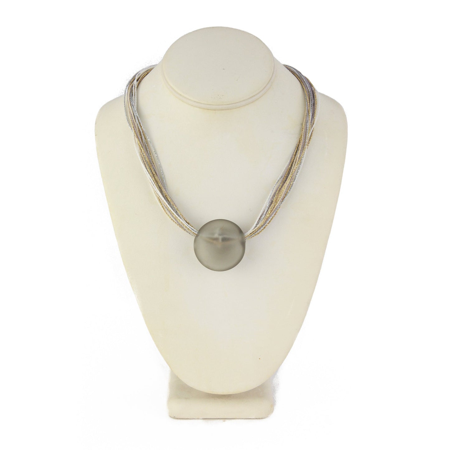 A sophisticated necklace featuring a hand-blown frosted grey glass focal bead strung on multi-strand waxed cord in neutral tones of grey, cream, and beige. Finished with a sterling silver hook-and-loop clasp, this piece offers timeless elegance for any occasion.