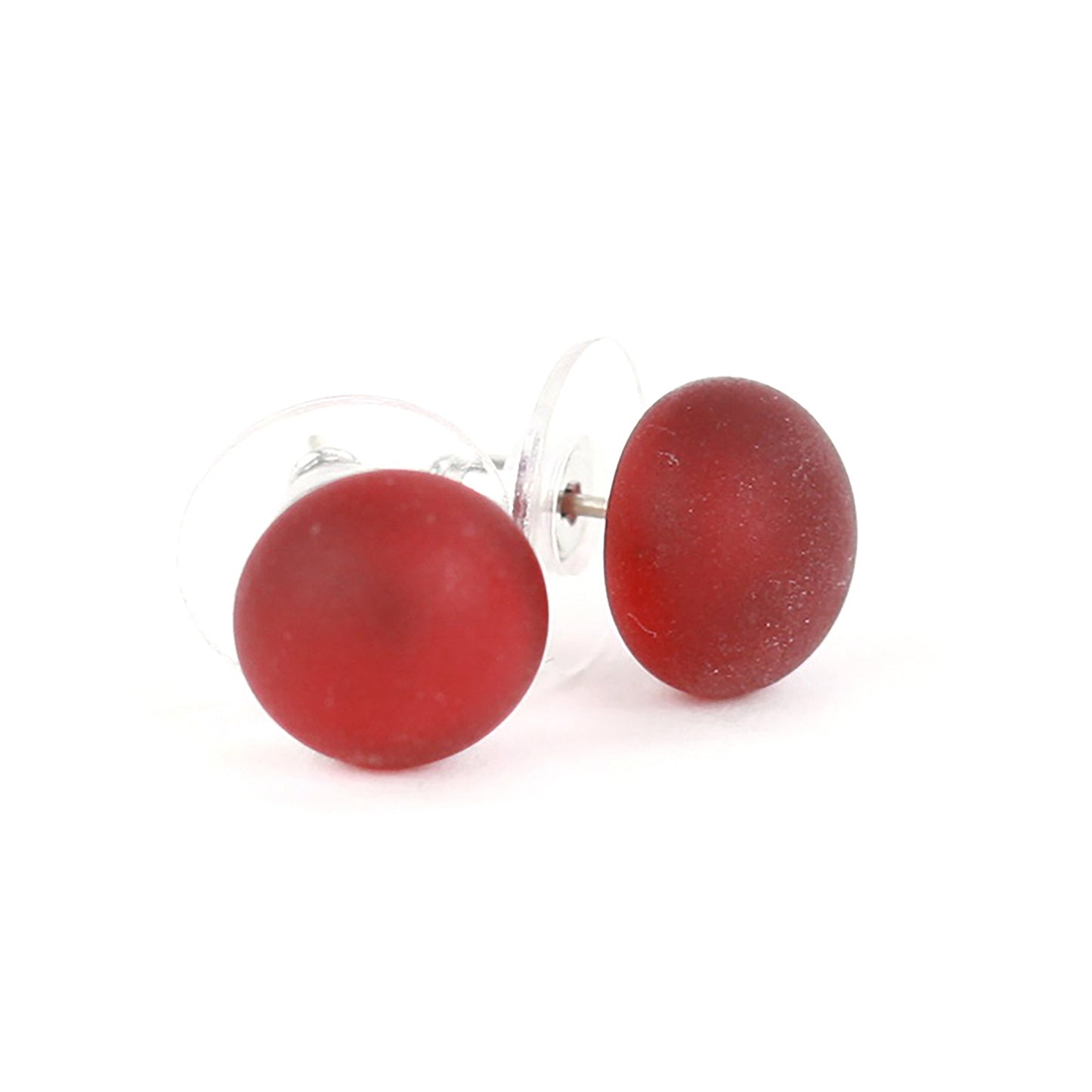 Small frosted red glass stud earrings with matte finish and sterling silver posts, paired with clear earring backs.