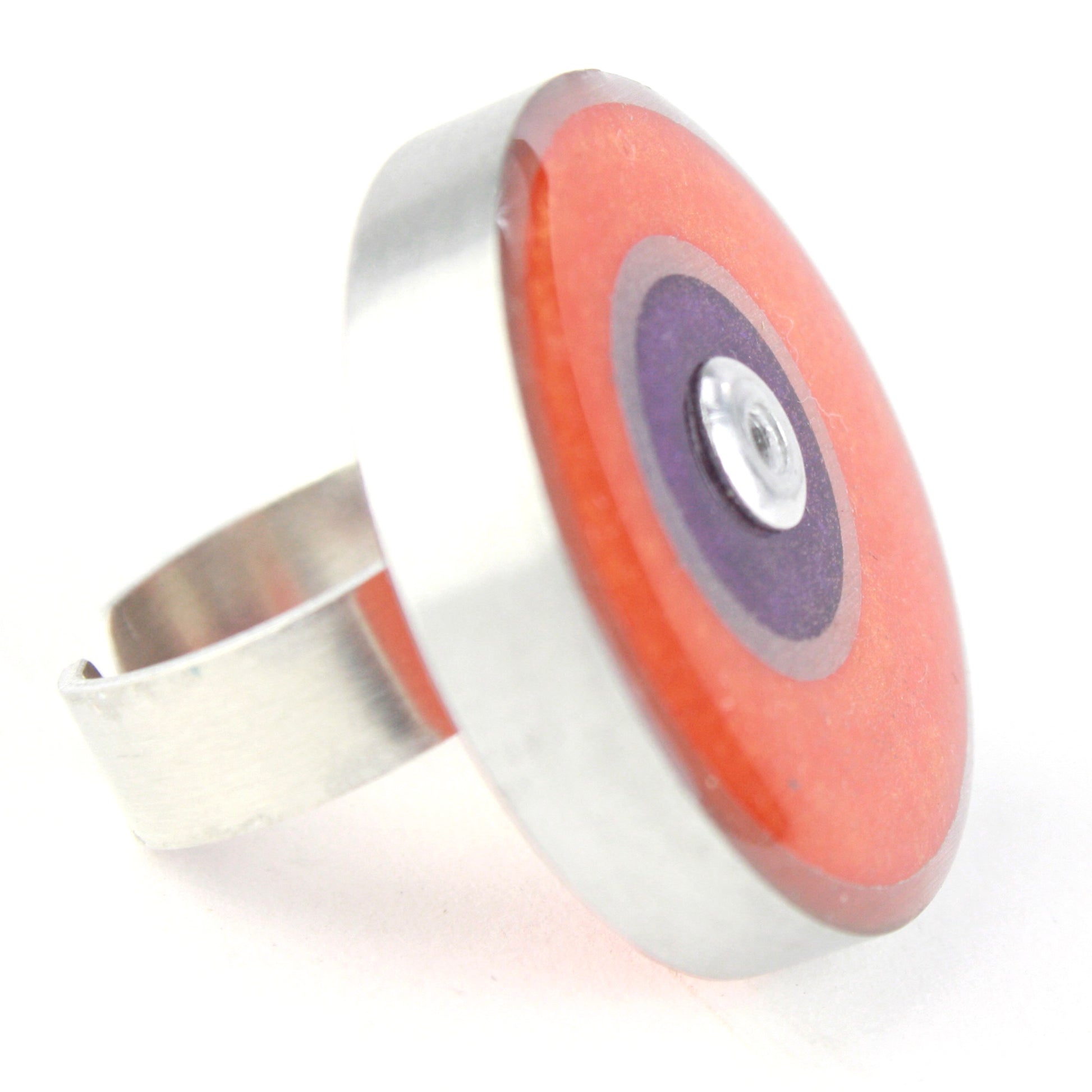 Orange and purple Resinique Double Circle Ring made from eco-resin and salvaged aluminum, featuring an adjustable band for a unique and sustainable accessory.