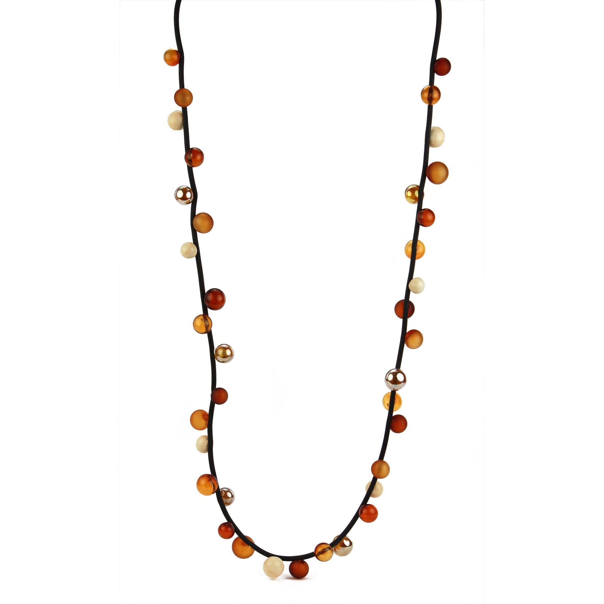 The "Bolla" necklace featuring hand-blown glass beads in amber, gold, and cream tones, strung on a steel cable through a rubber cord, worn long or doubled up.