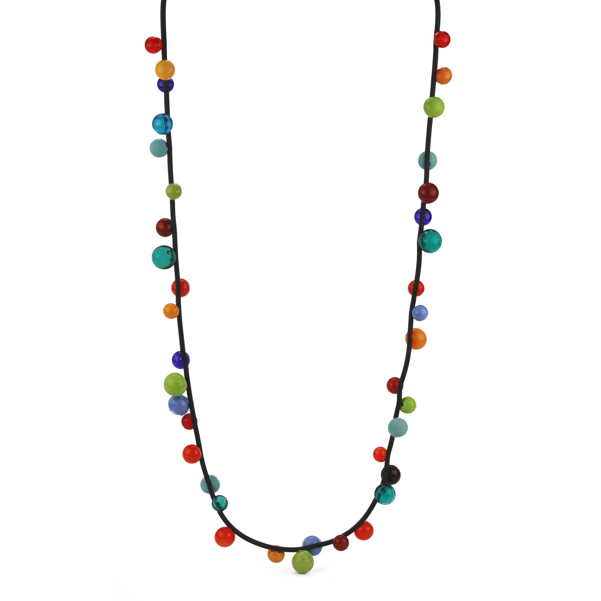 "Bolla" necklace featuring vibrant hand-blown glass beads in rainbow colors, strung on a steel cable threaded through a rubber cord, worn long or doubled.

