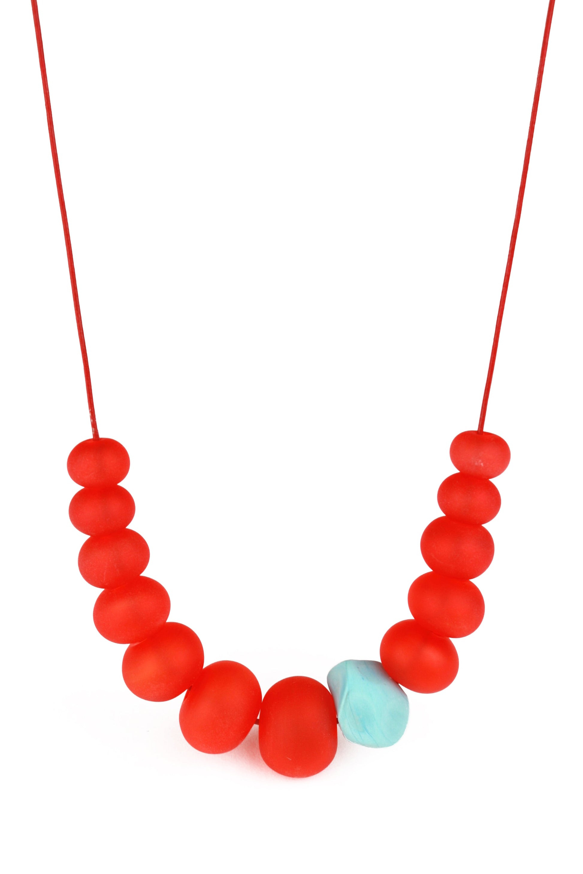 Necklace of hand blown and sandblasted hollow beads in velvety cherry red glass paired with a turquoise glass nugget bead and strung on adjustable leather