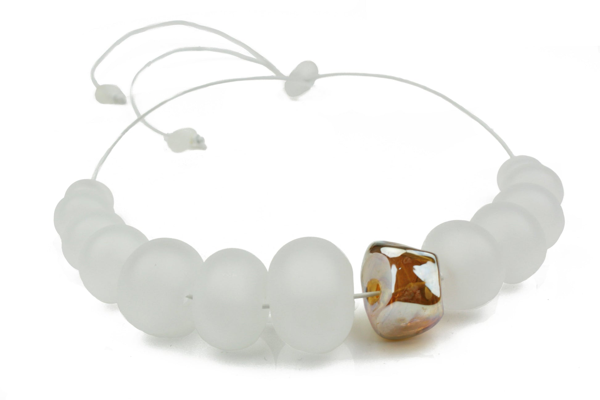 Necklace of hand blown and sandblasted hollow beads in soft white glass paired with a gold glass nugget bead and strung on adjustable leather