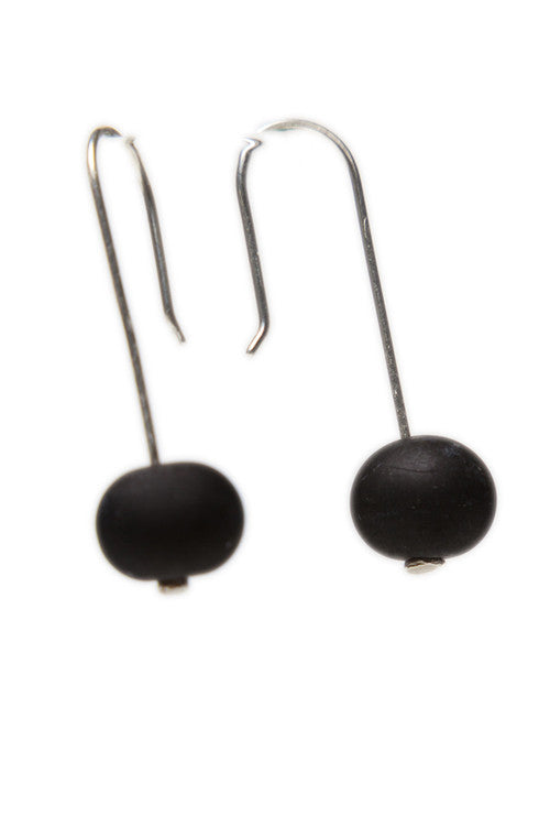 Handmade sandblasted black glass beads hung on sterling silver long ear wires.