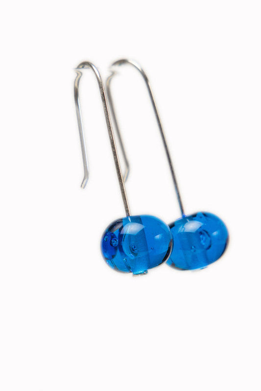 Handmade Caribbean blue glass beads hung on sterling silver long ear wires.